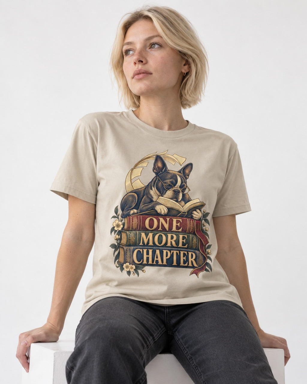 One More Chapter Boston Terrier T-Shirt in Sand, worn by a seated model
