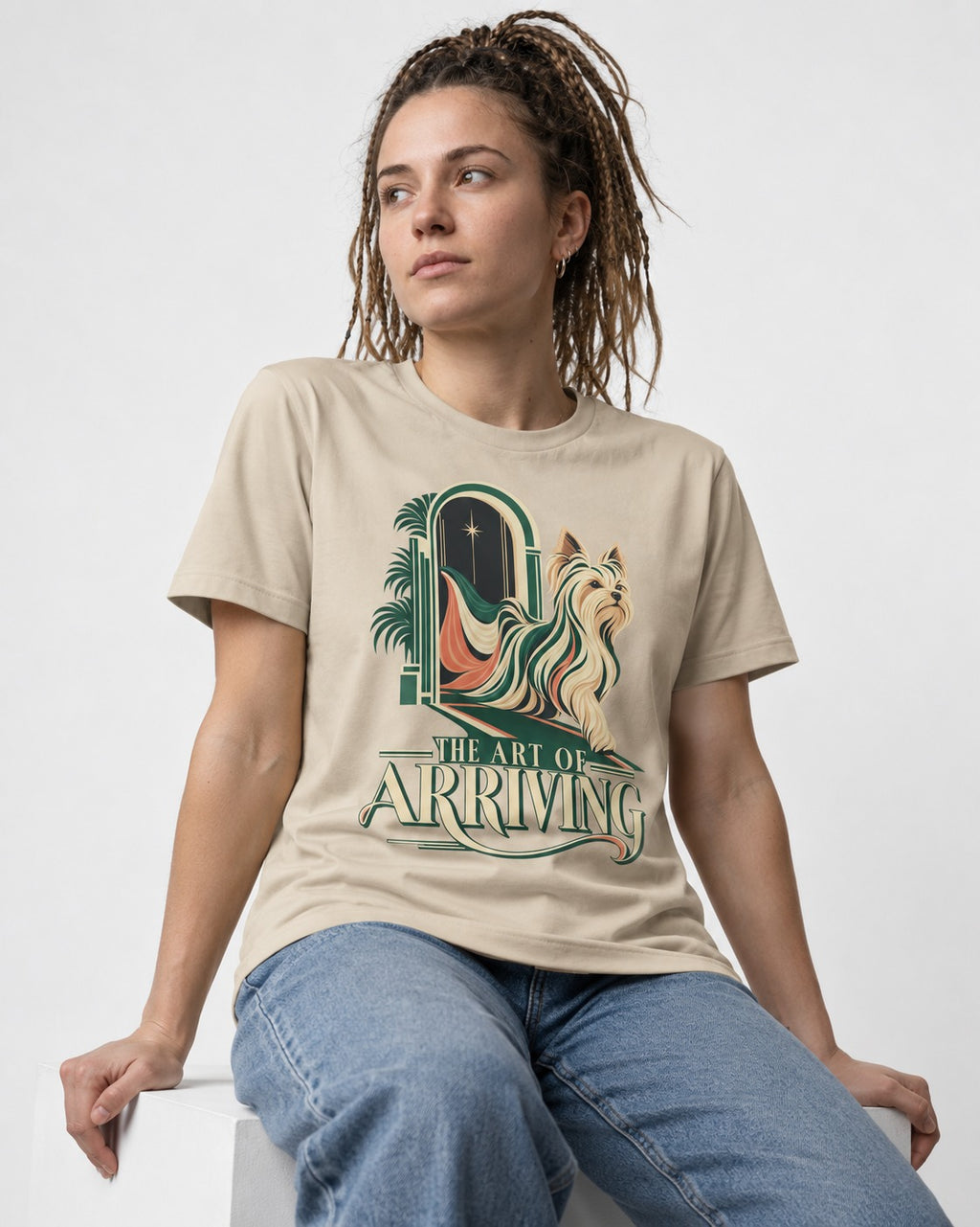 Yorkshire Terrier Arriving T-Shirt in Sand, worn by a seated model