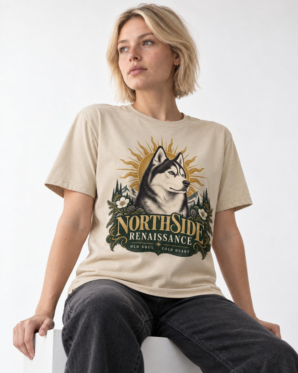 Northside Renaissance Husky T-Shirt in Sand, worn by a seated model