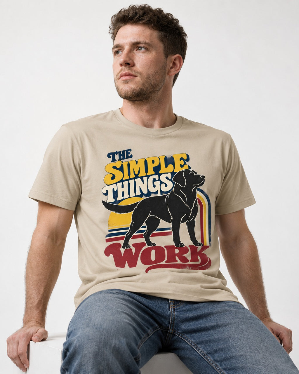 The Simple Things Work Labrador Retriever T-Shirt in Sand, worn by a seated model