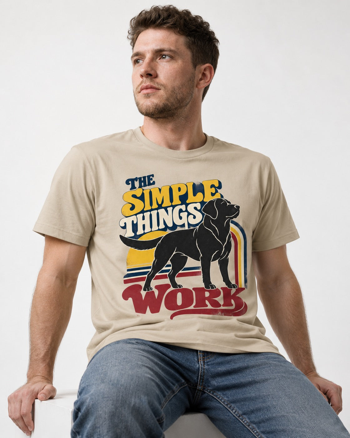 The Simple Things Work Labrador Retriever T-Shirt in Sand, worn by a seated model