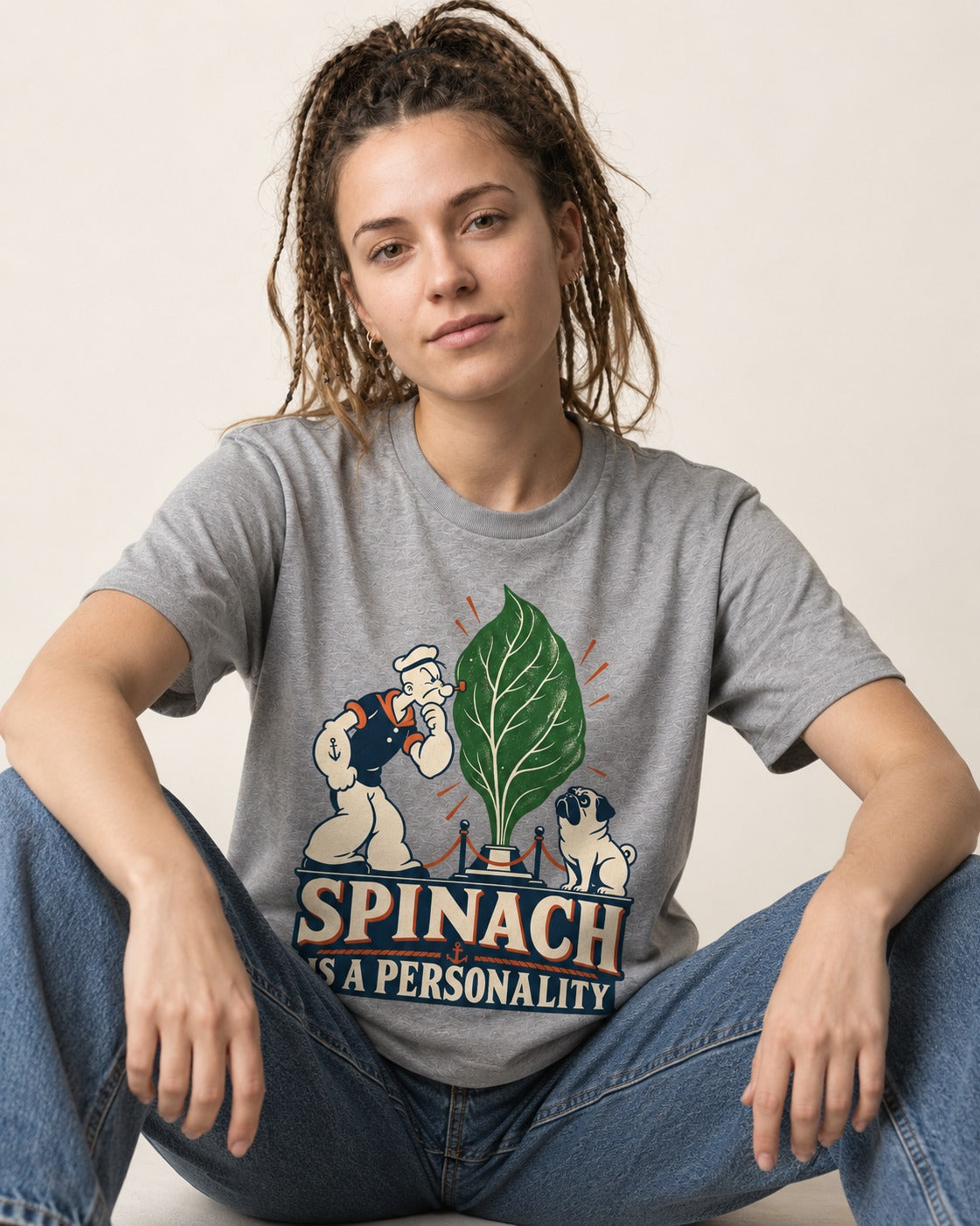 Pug Spinach Is a Personality T-Shirt in Sport Grey, worn by a seated model