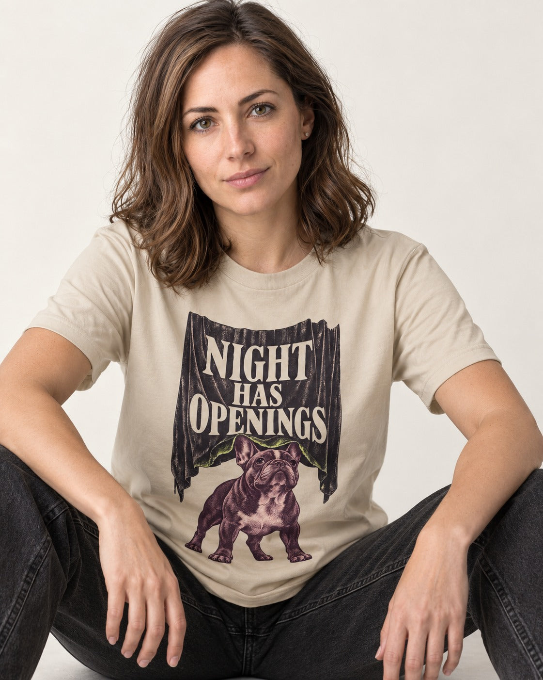 Night Has Openings Frenchie T-Shirt in Sand, worn by a seated model