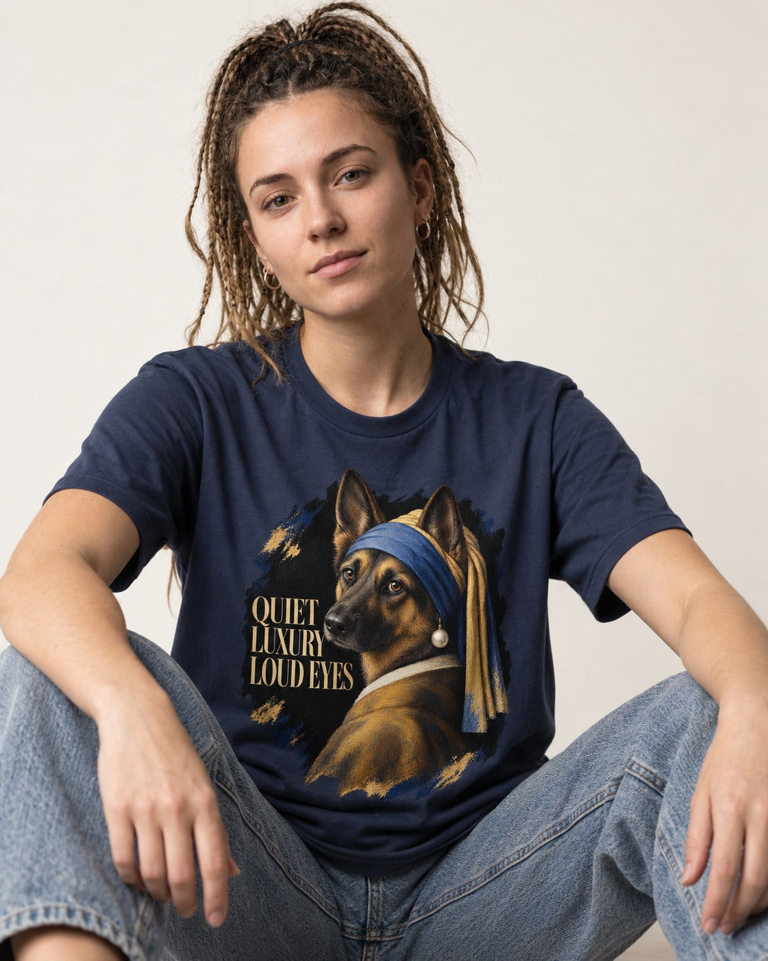 German Shepherd Dog Quiet Luxury Loud Eyes Pearl Portrait T-Shirt in Navy, worn by a seated model
