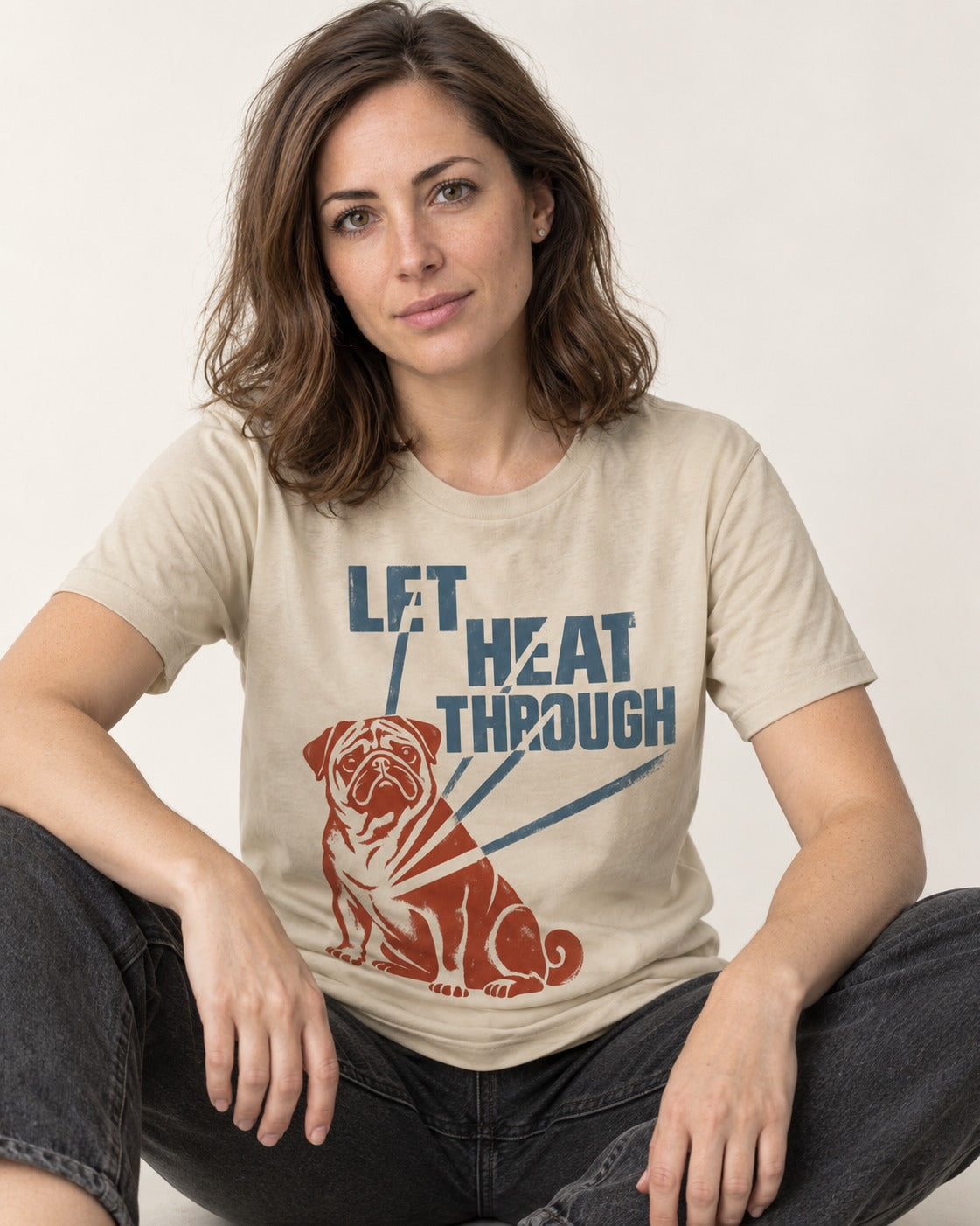 Let the Pug Through T-Shirt in Sand, worn by a seated model
