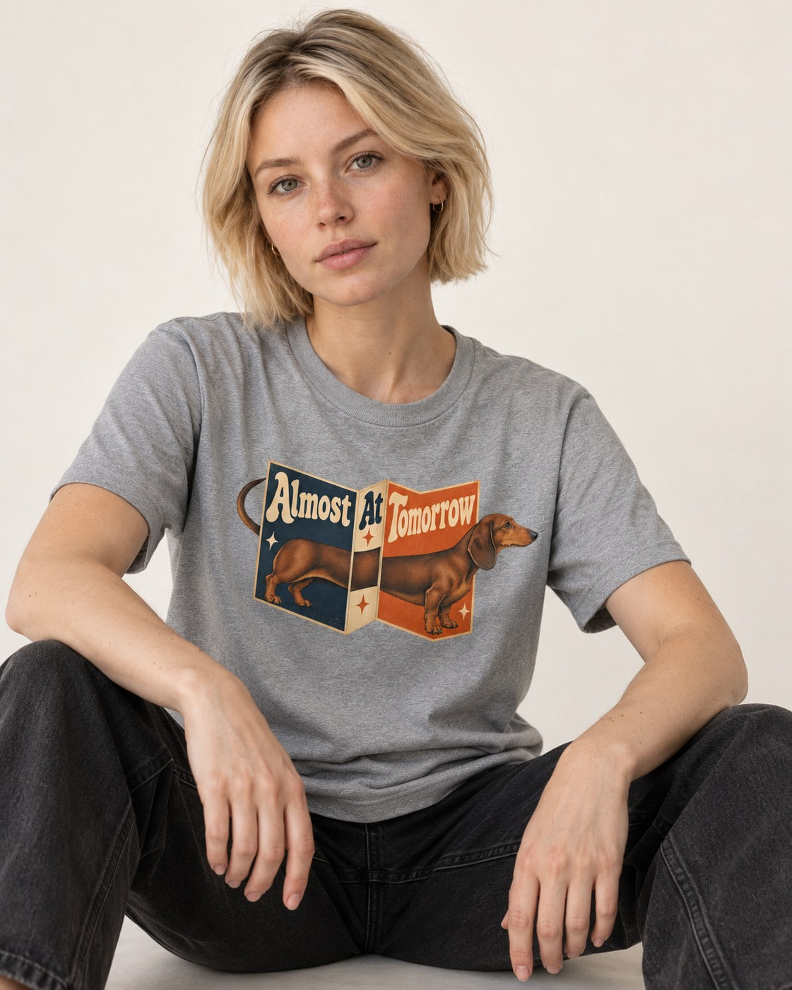 Dachshund Almost At Tomorrow Folding Screen Graphic T-Shirt in Sport Grey, worn by a seated model