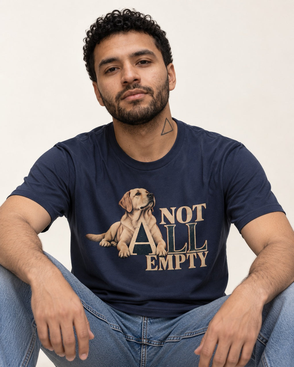 Labrador Retriever Not All Empty Lounging Typography Graphic T-Shirt in Navy, worn by a seated model