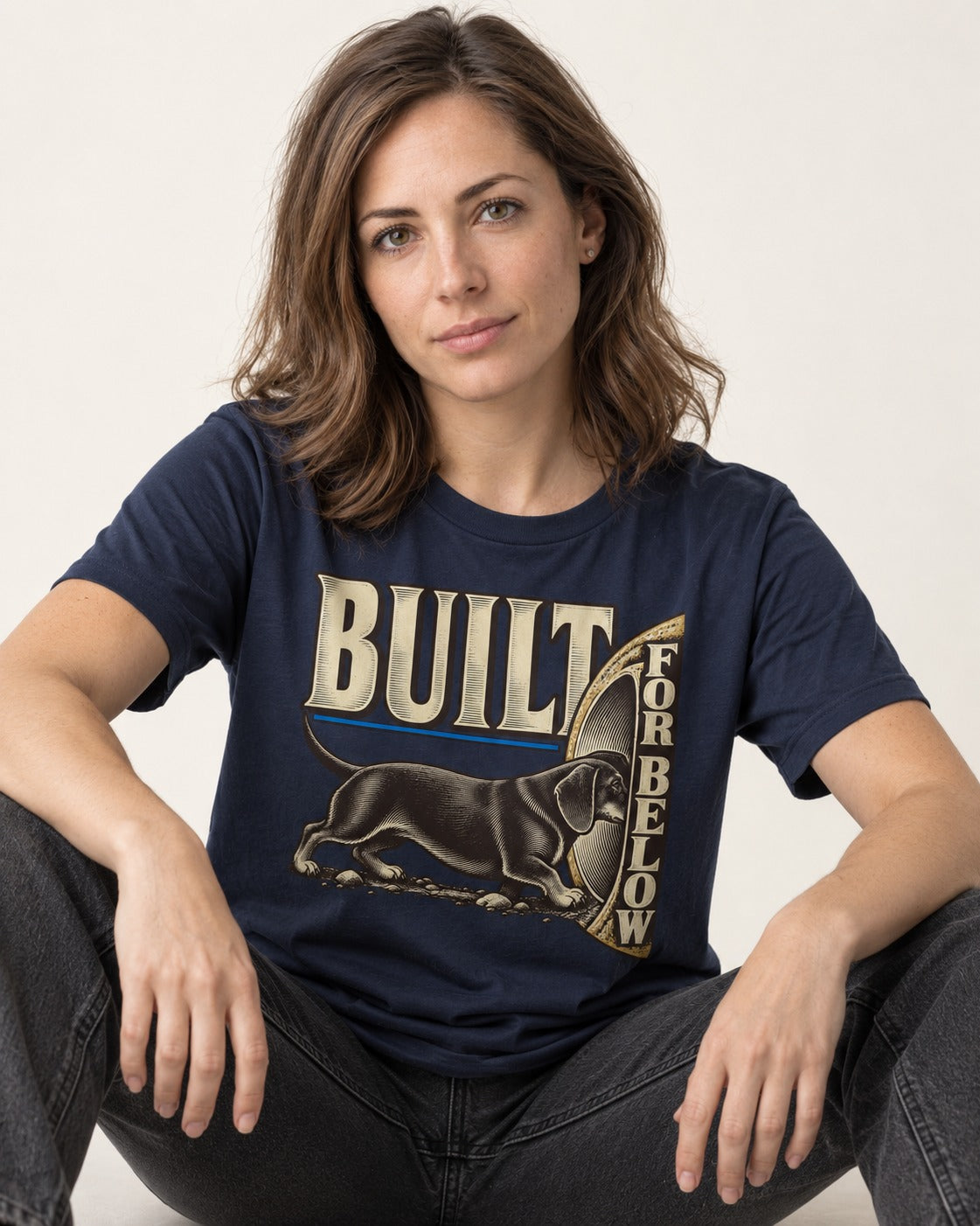 Dachshund Built for Below Vintage Burrow Graphic T-Shirt in Navy, worn by a seated model
