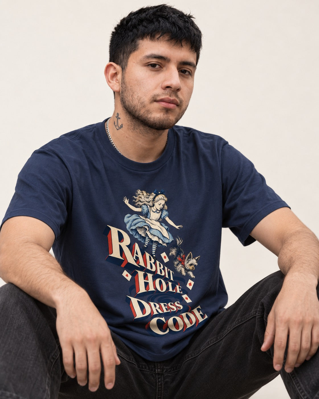 Yorkshire Terrier Rabbit Hole Dress Code Wonderland Graphic T-Shirt in Navy, worn by a seated model