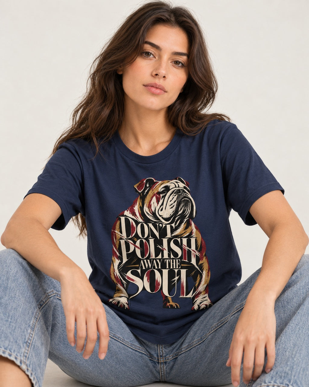 English Bulldog Don't Polish Away the Soul Typography Graphic T-Shirt in Navy, worn by a seated model