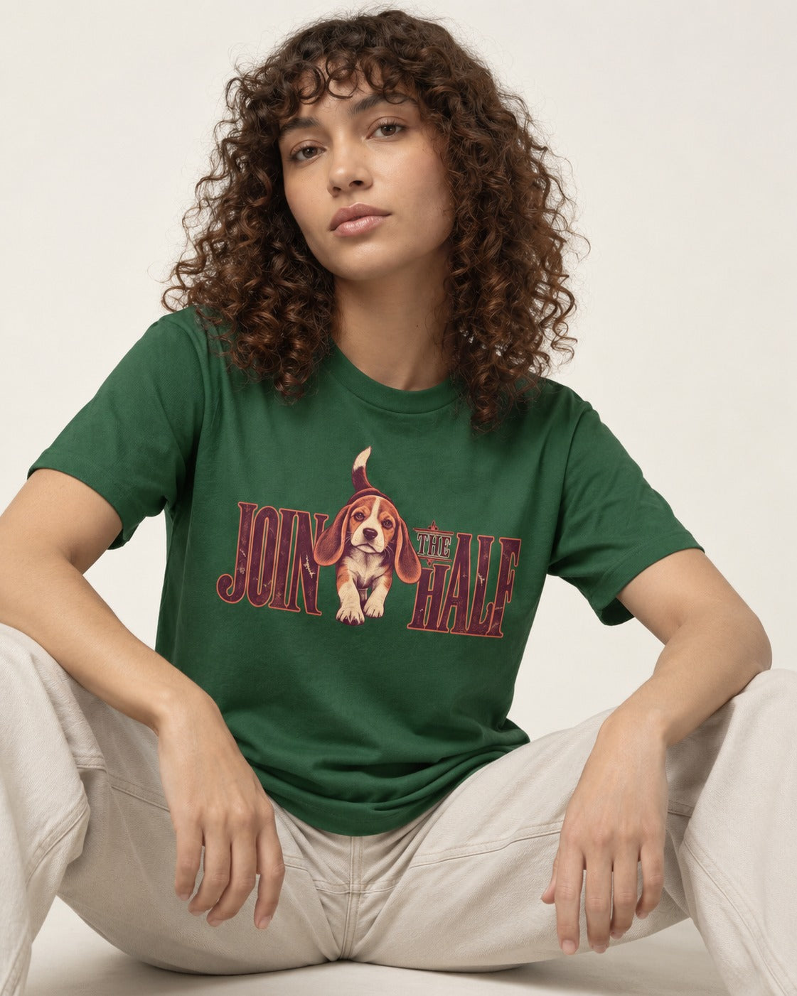 Beagle Join The Half T-Shirt in Forest Green, worn by a seated model