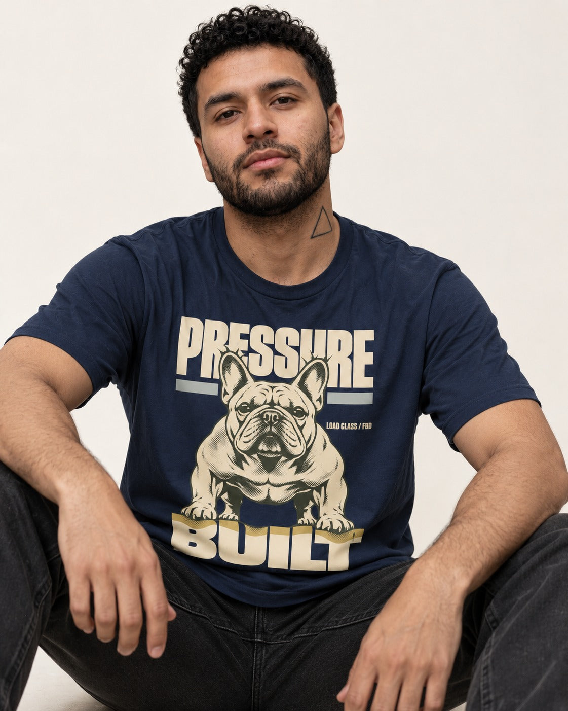 Frenchie Pressure Built Load Class Graphic T-Shirt in Navy, worn by a seated model