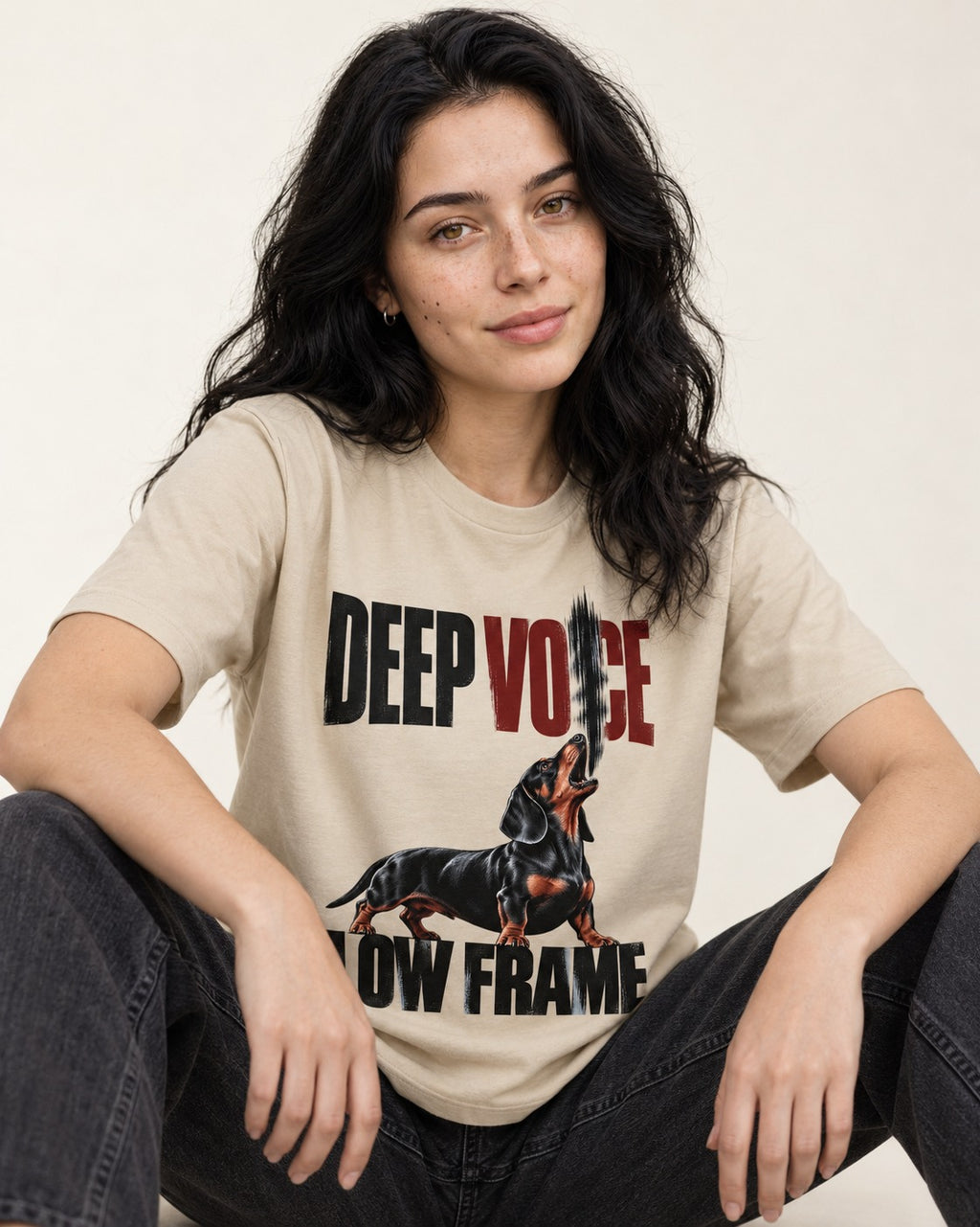 Deep Voice Low Frame Dachshund T-Shirt in Sand, worn by a seated model