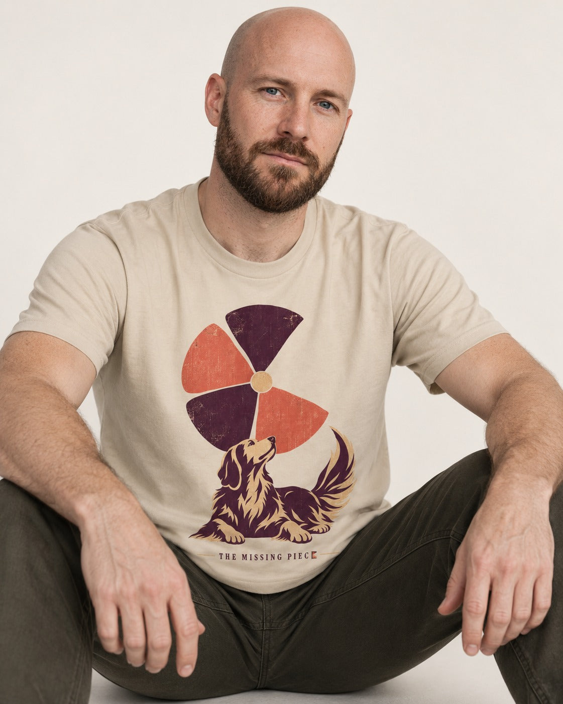 Golden Retriever Is My Missing Piece T-Shirt in Sand, worn by a seated model