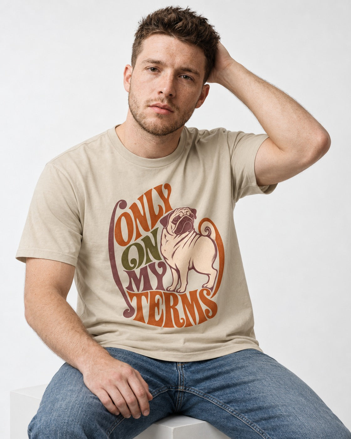 Pug Only on My Terms T-Shirt in Sand, worn by a seated model