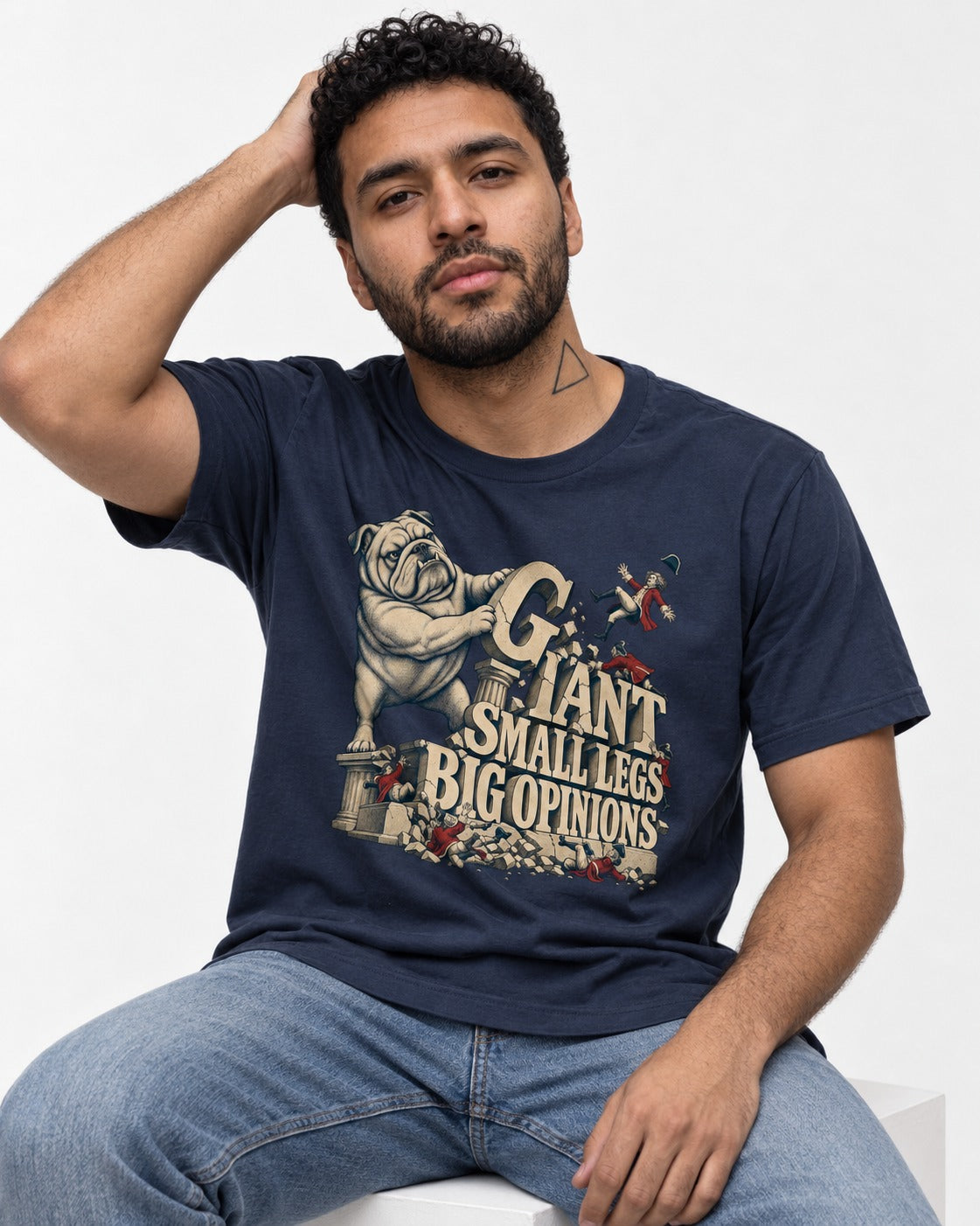 English Bulldog Giant Small Legs Big Opinions Monument Graphic T-Shirt in Navy, worn by a seated model