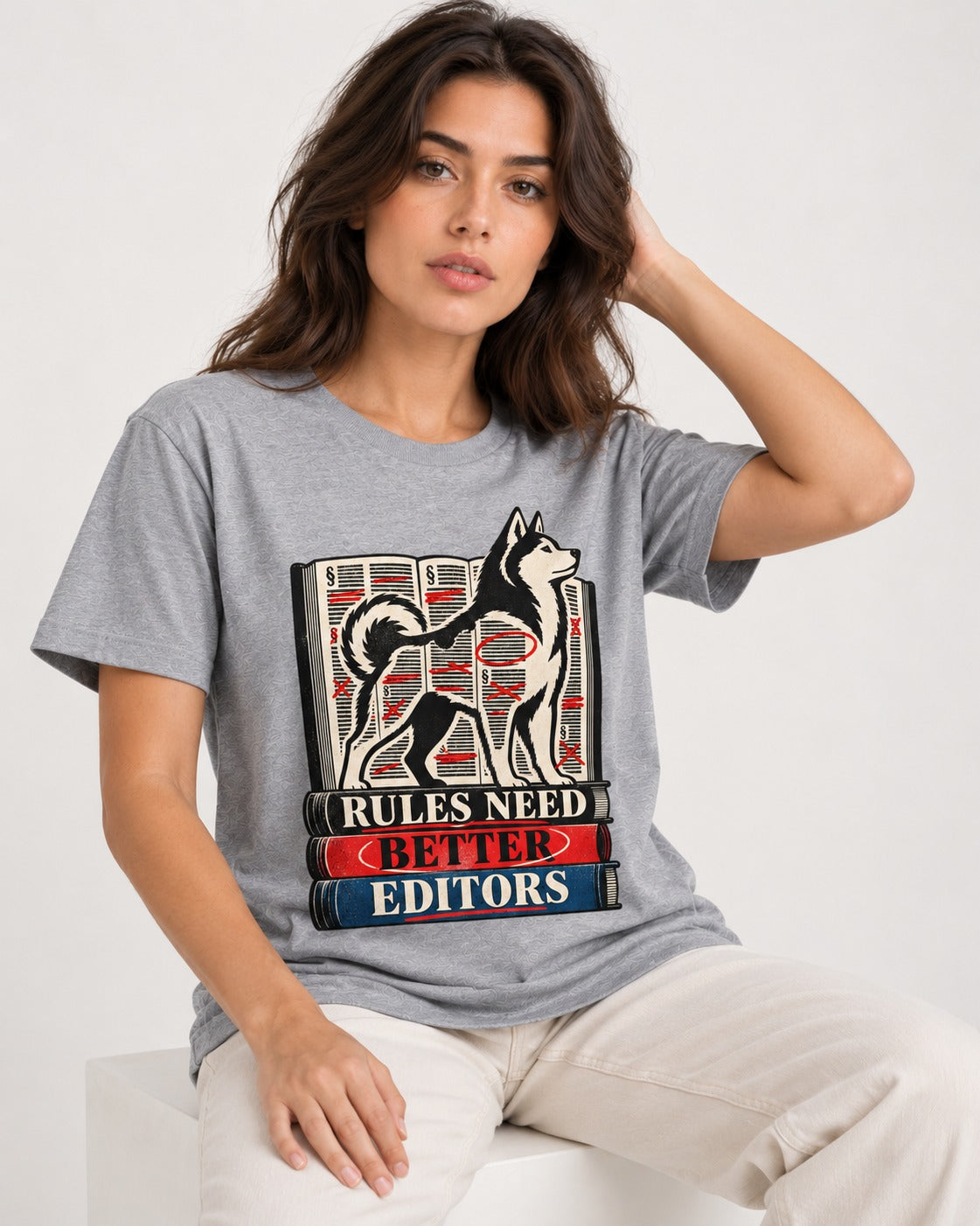 Husky Rules Need Better Editors Book Stack Graphic T-Shirt in Sport Grey, worn by a seated model