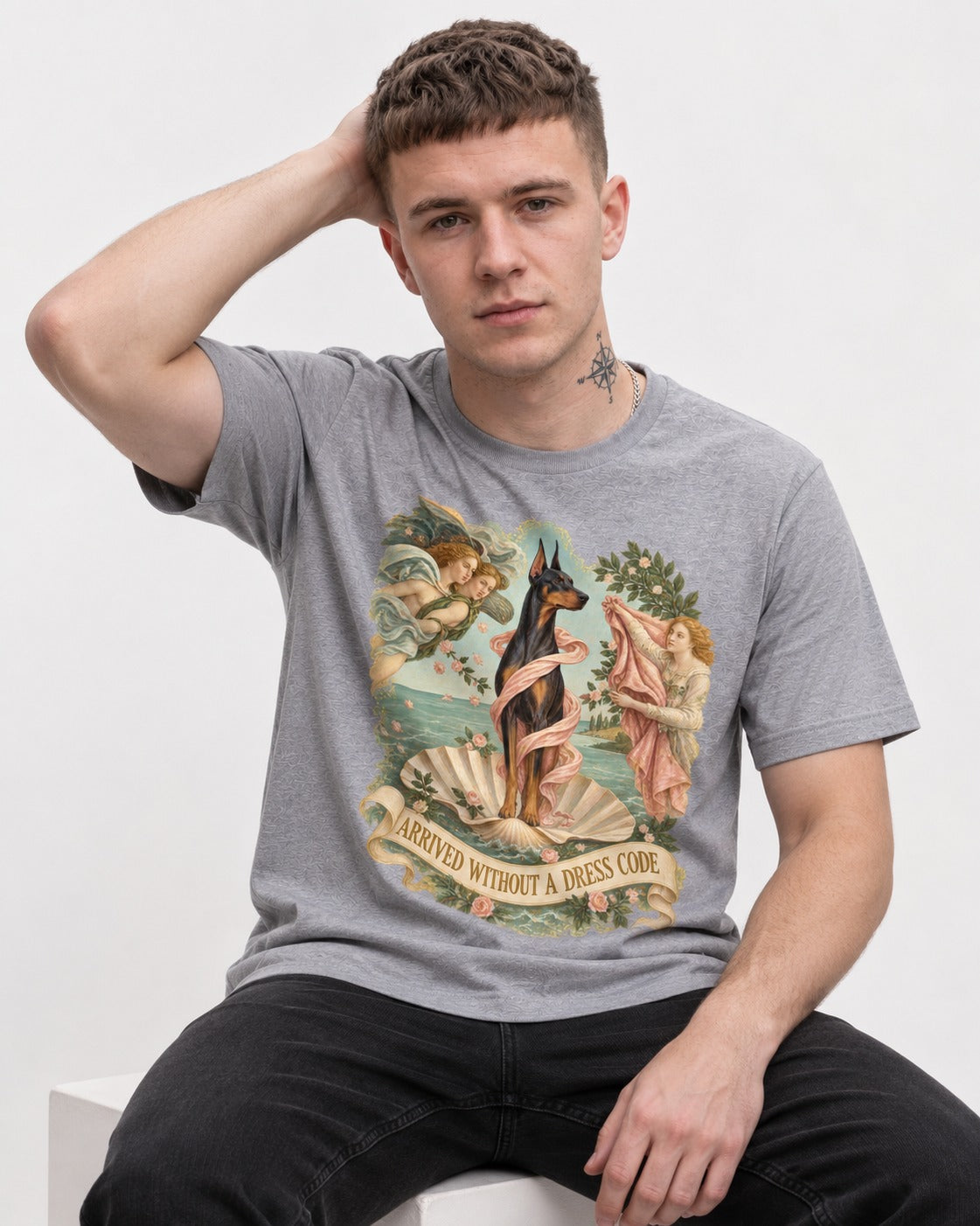 Doberman Arrived Without a Dress Code Renaissance Graphic T-Shirt in Sport Grey, worn by a seated model