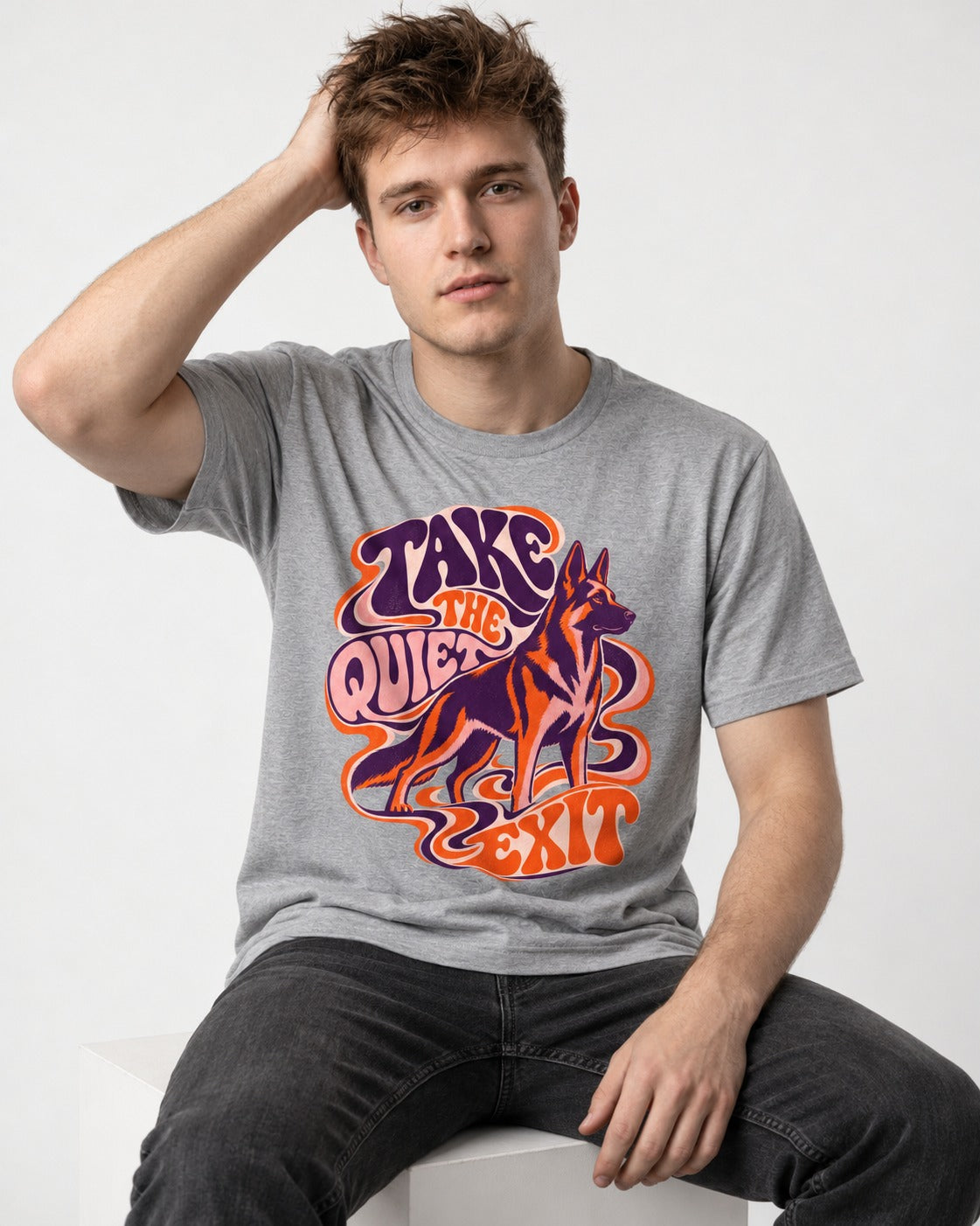 Take The Quiet Exit Psychedelic German Shepherd Dog Graphic T-Shirt in Sport Grey, worn by a seated model