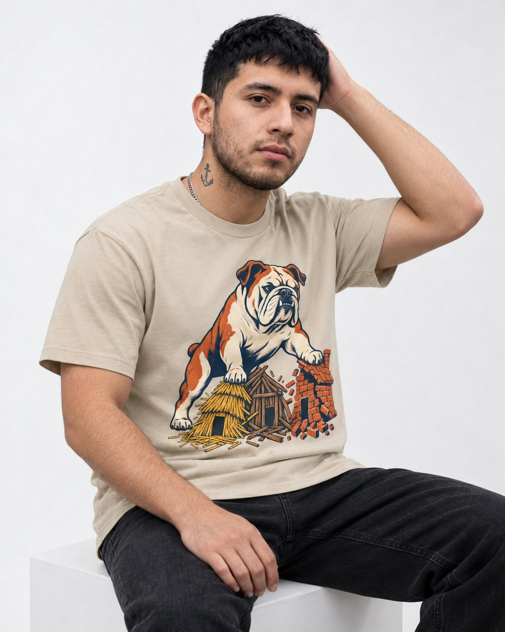 English Bulldog Huff and Puff T-Shirt in Sand, worn by a seated model