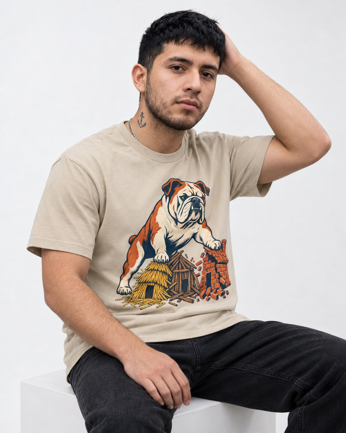 English Bulldog Huff and Puff T-Shirt in Sand, worn by a seated model