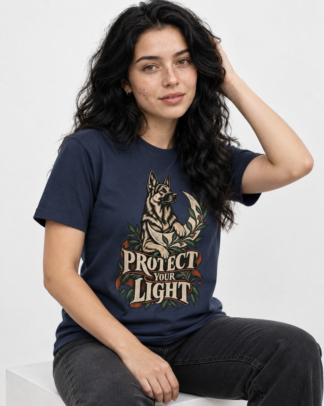 Protect Your Light Moon Botanical German Shepherd Dog Graphic T-Shirt in Navy, worn by a seated model