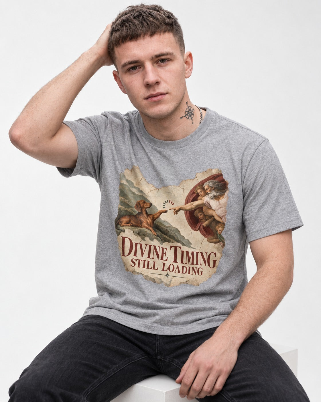 Dachshund's Divine Timing T-Shirt in Sport Grey, worn by a seated model