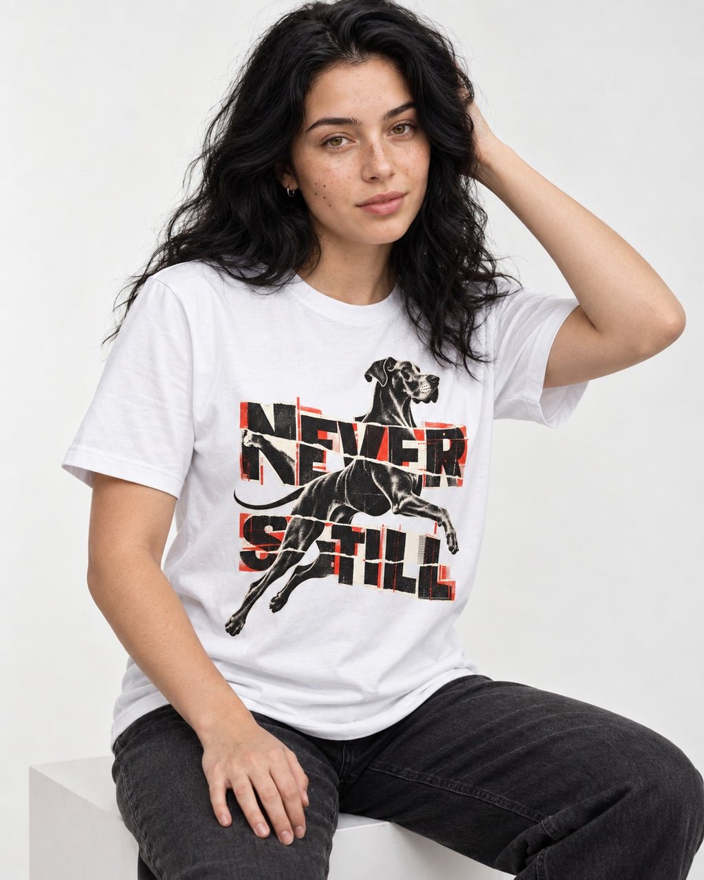 Great Dane Never Still Leaping Collage Graphic T-Shirt in White, worn by a seated model
