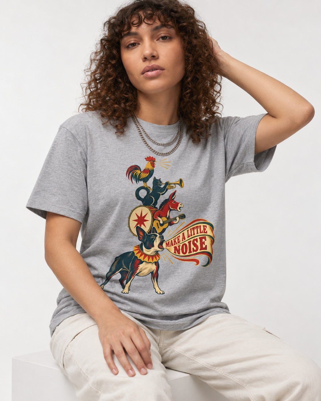 Boston Terrier Make A Little Noise T-Shirt in Sport Grey, worn by a seated model