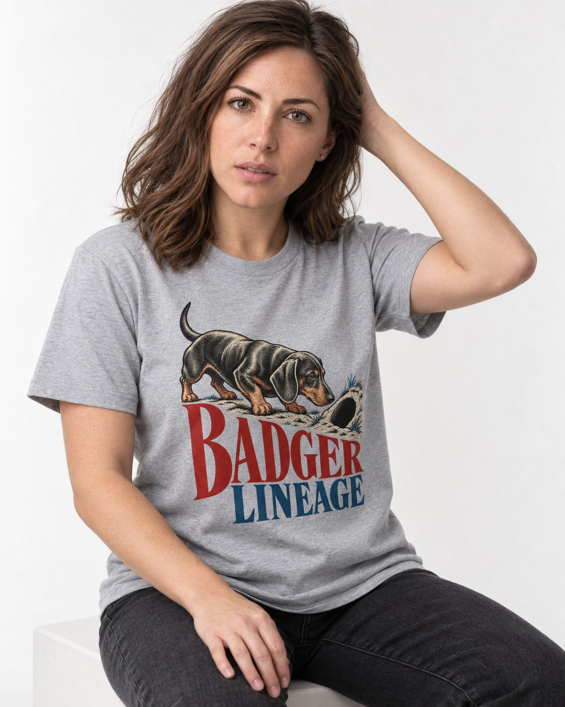 Dachshund Badger Lineage T-Shirt in Sport Grey, worn by a seated model