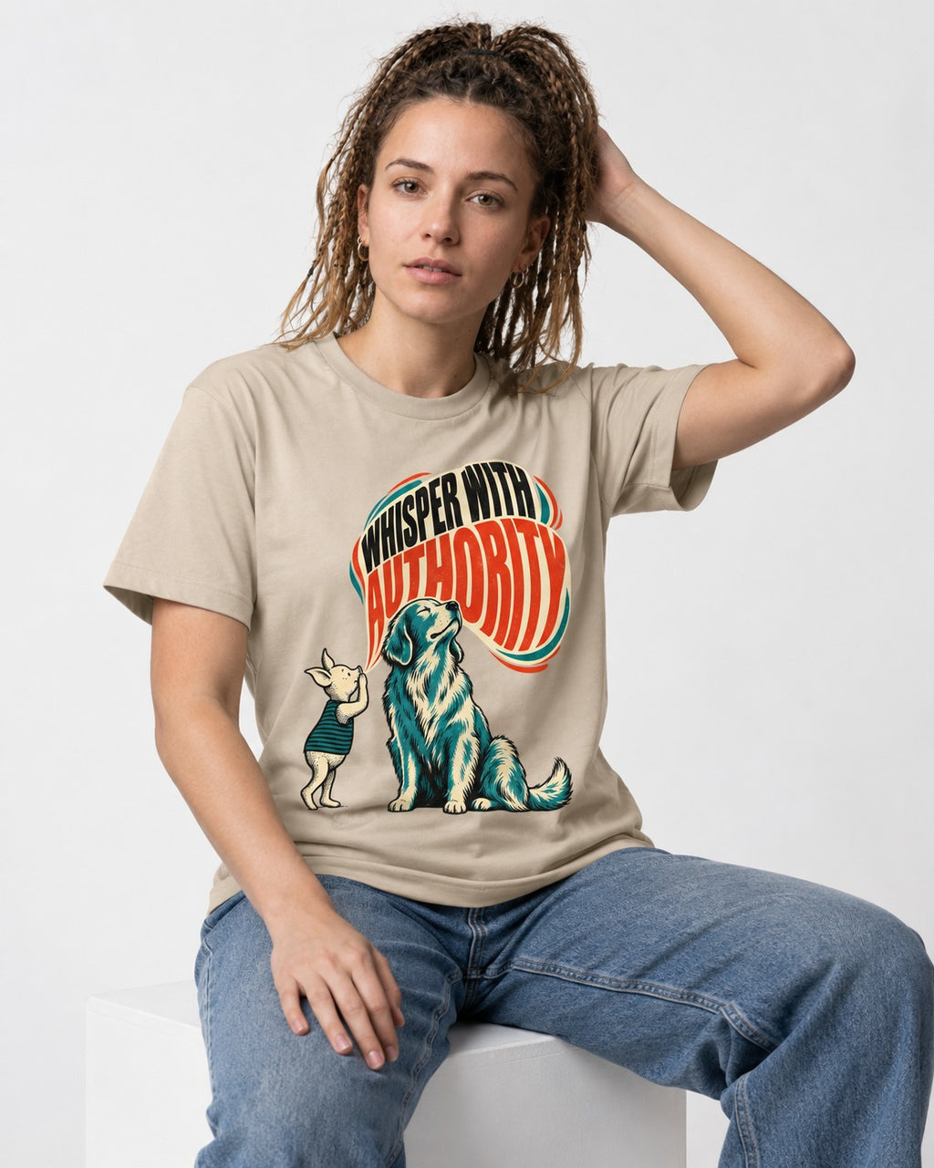 Golden Retriever Whisper with Authority T-Shirt in Sand, worn by a seated model