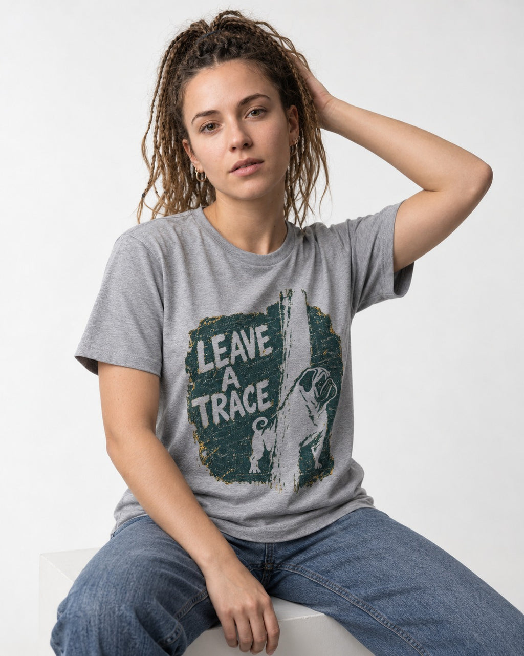 Pug Leaves a Trace T-Shirt in Sport Grey, worn by a seated model