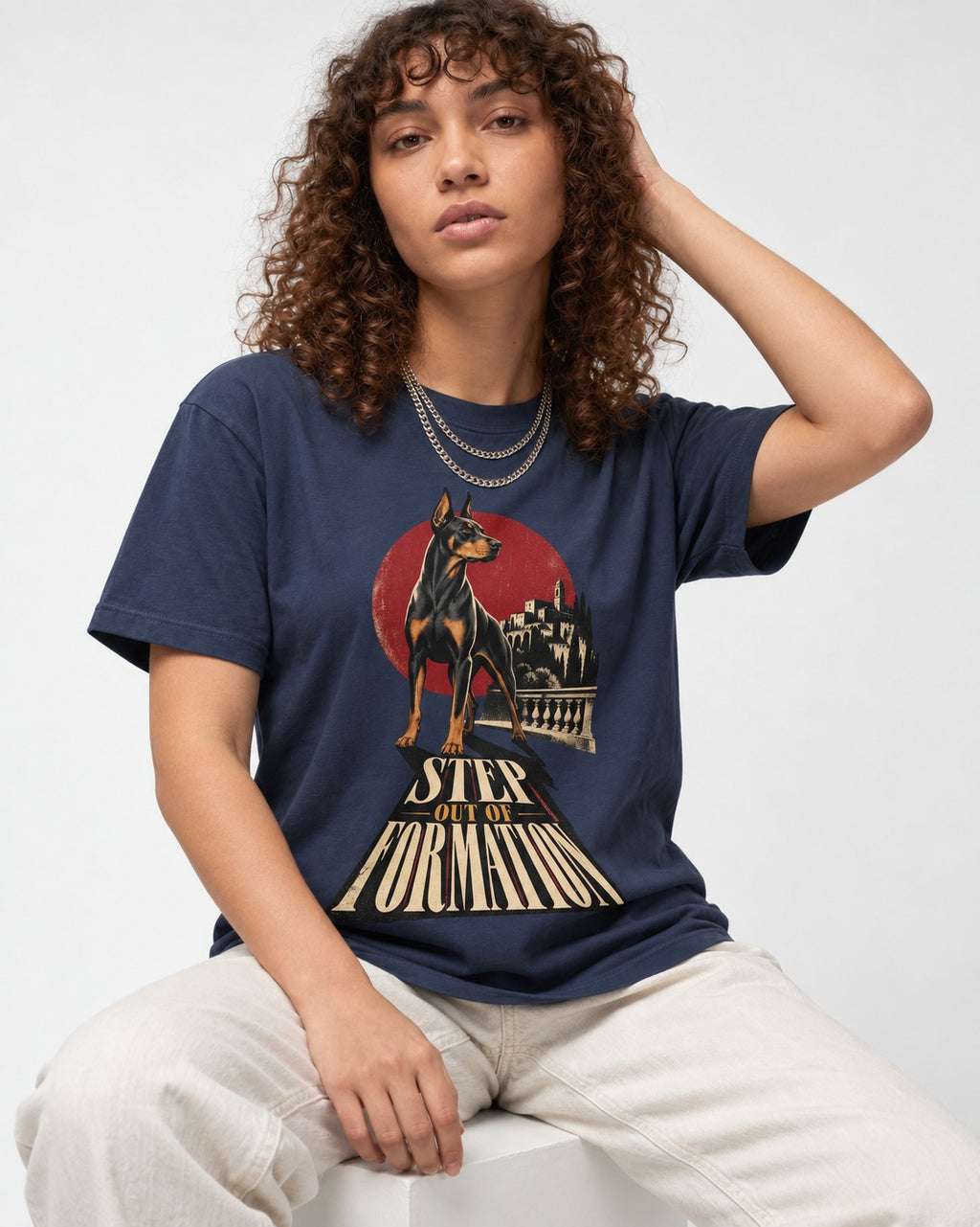 Doberman Step Out of Formation Road Vista Graphic T-Shirt in Navy, worn by a seated model