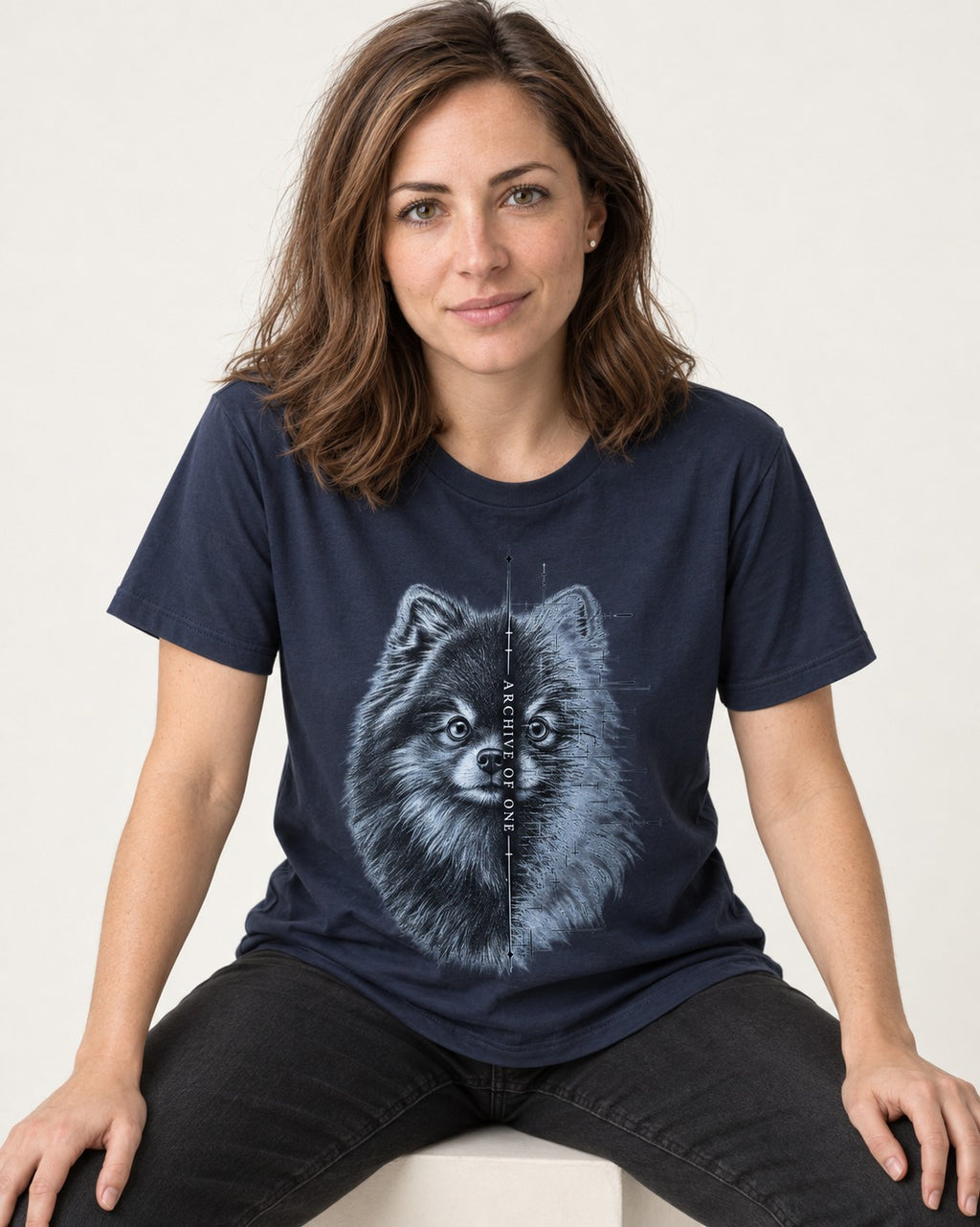 Pomeranian Archive of One Split Portrait Graphic T-Shirt in Navy, worn by a seated model