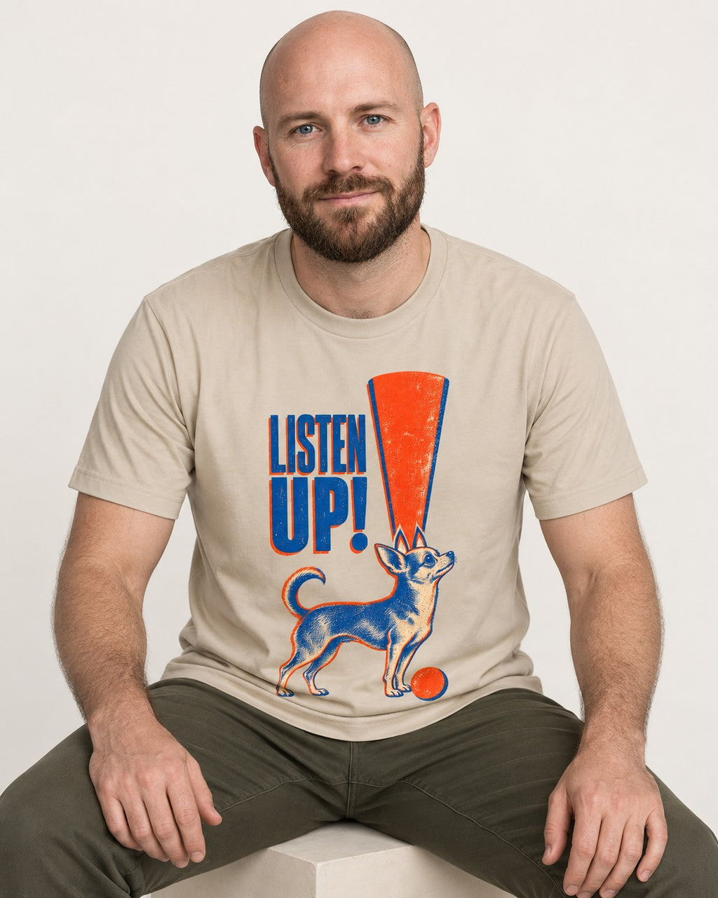 Listen Up Chihuahua T-Shirt in Sand, worn by a seated model