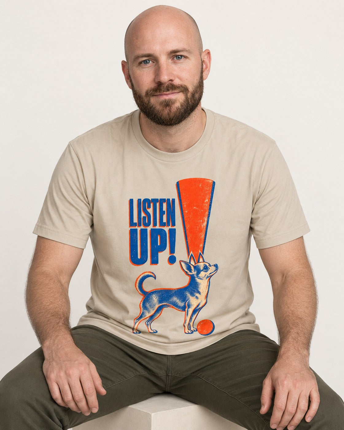 Listen Up Chihuahua T-Shirt in Sand, worn by a seated model