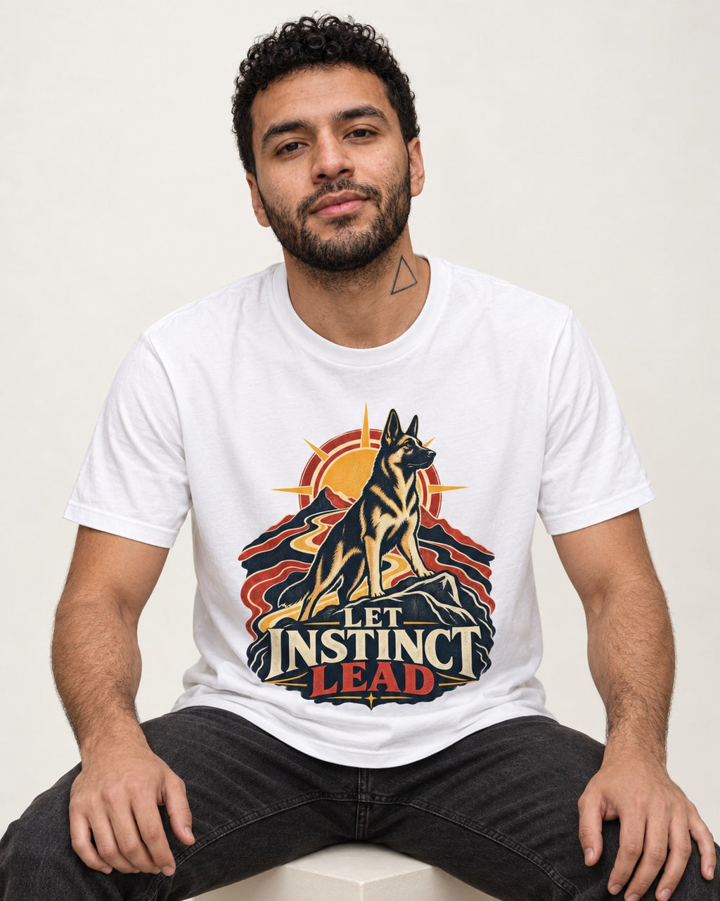 Let Instinct Lead Sunrise German Shepherd Dog Graphic T-Shirt in White, worn by a seated model