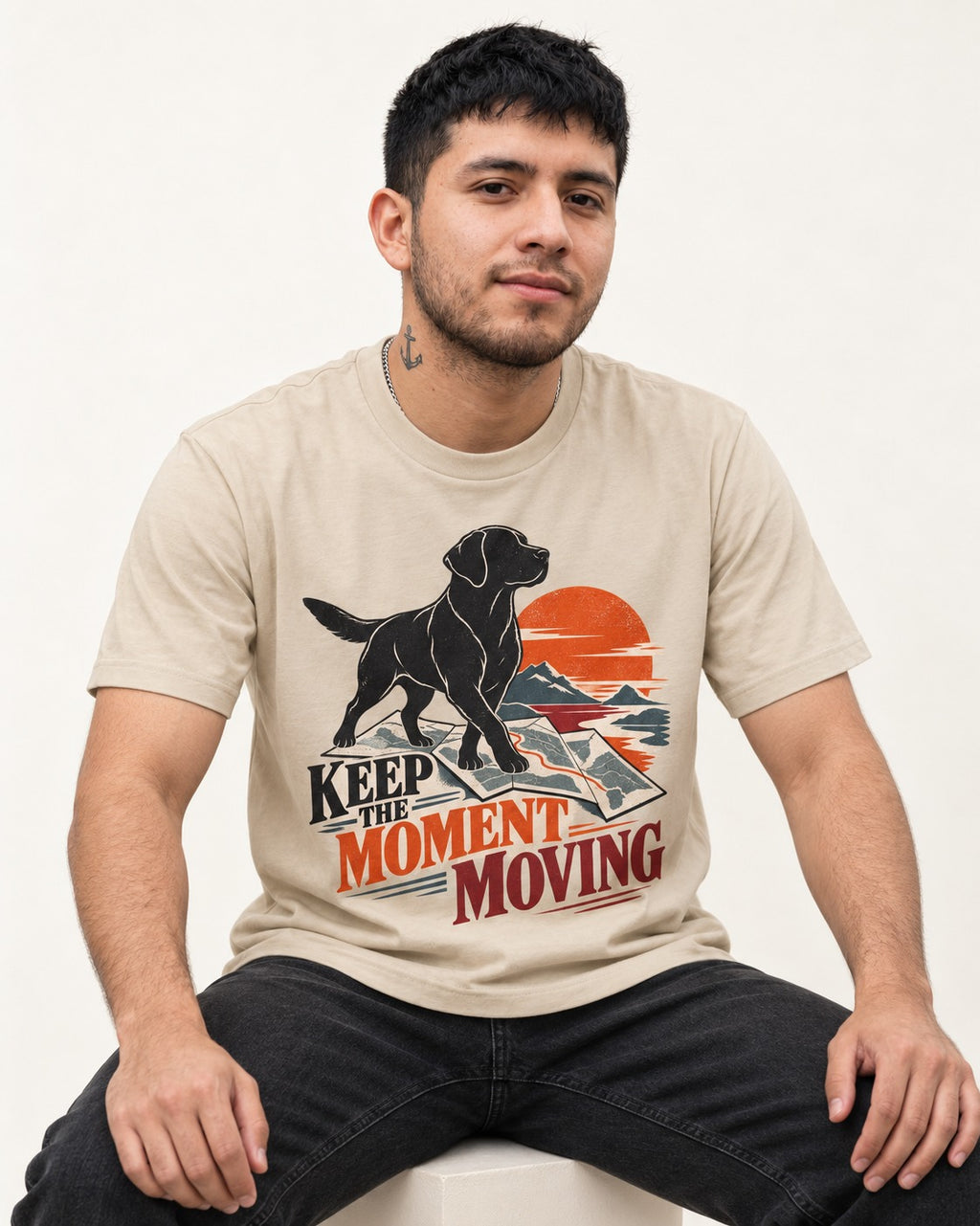 Keep the Moment Moving Labrador Retriever T-Shirt in Sand, worn by a seated model