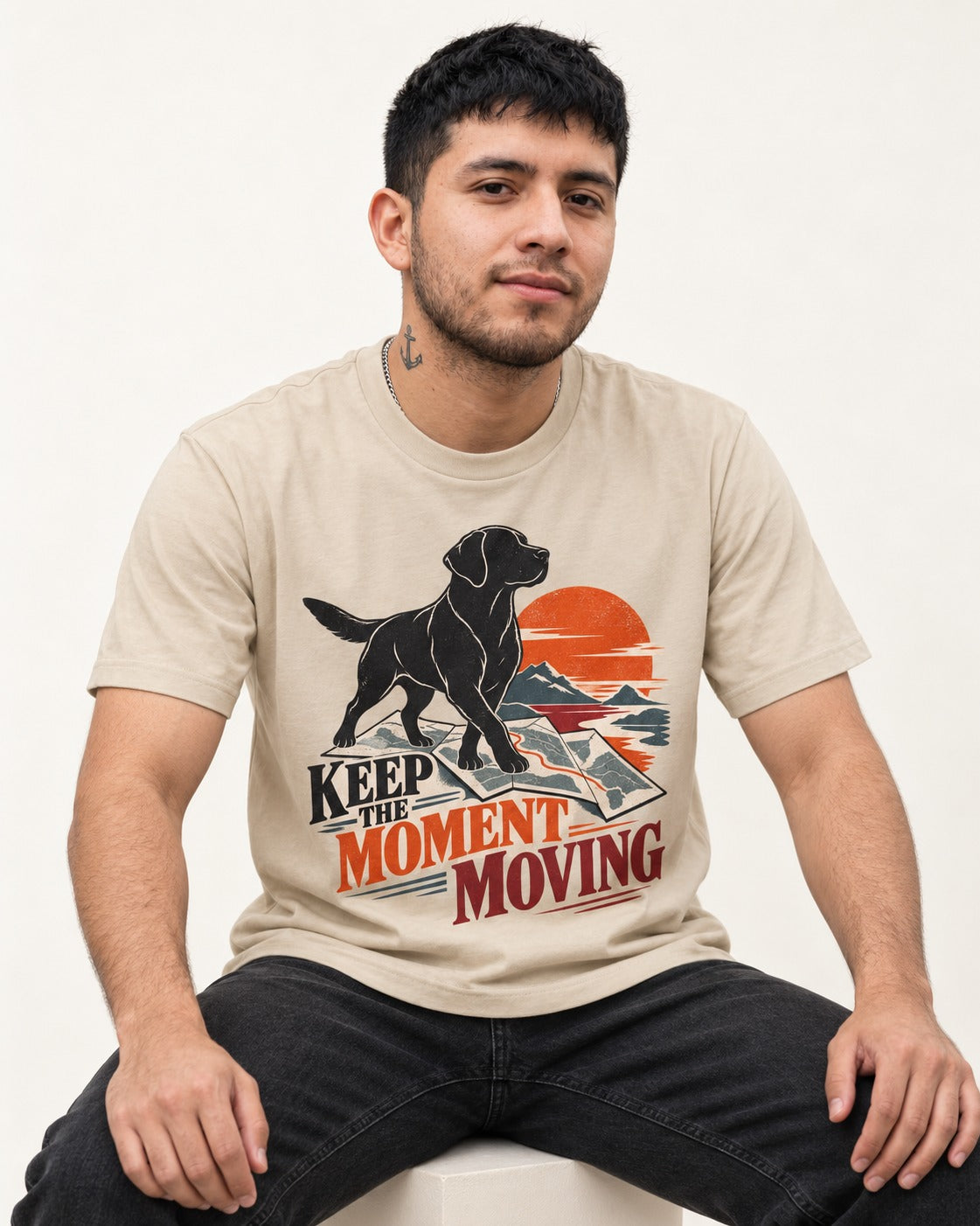 Keep the Moment Moving Labrador Retriever T-Shirt in Sand, worn by a seated model
