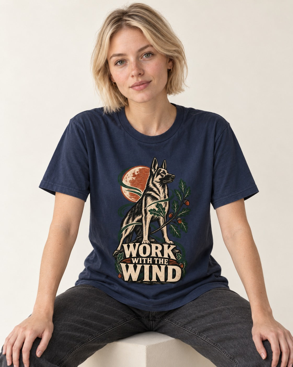 Work With The Wind Botanical Woodcut German Shepherd Dog Graphic T-Shirt in Navy, worn by a seated model