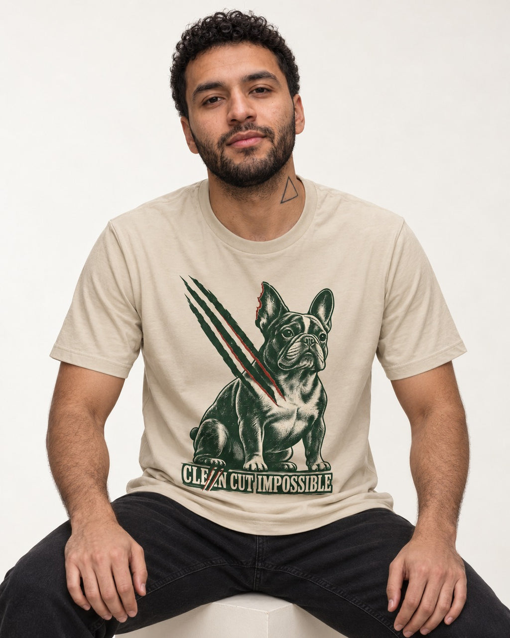 Frenchie Clean Cut Impossible T-Shirt in Sand, worn by a seated model