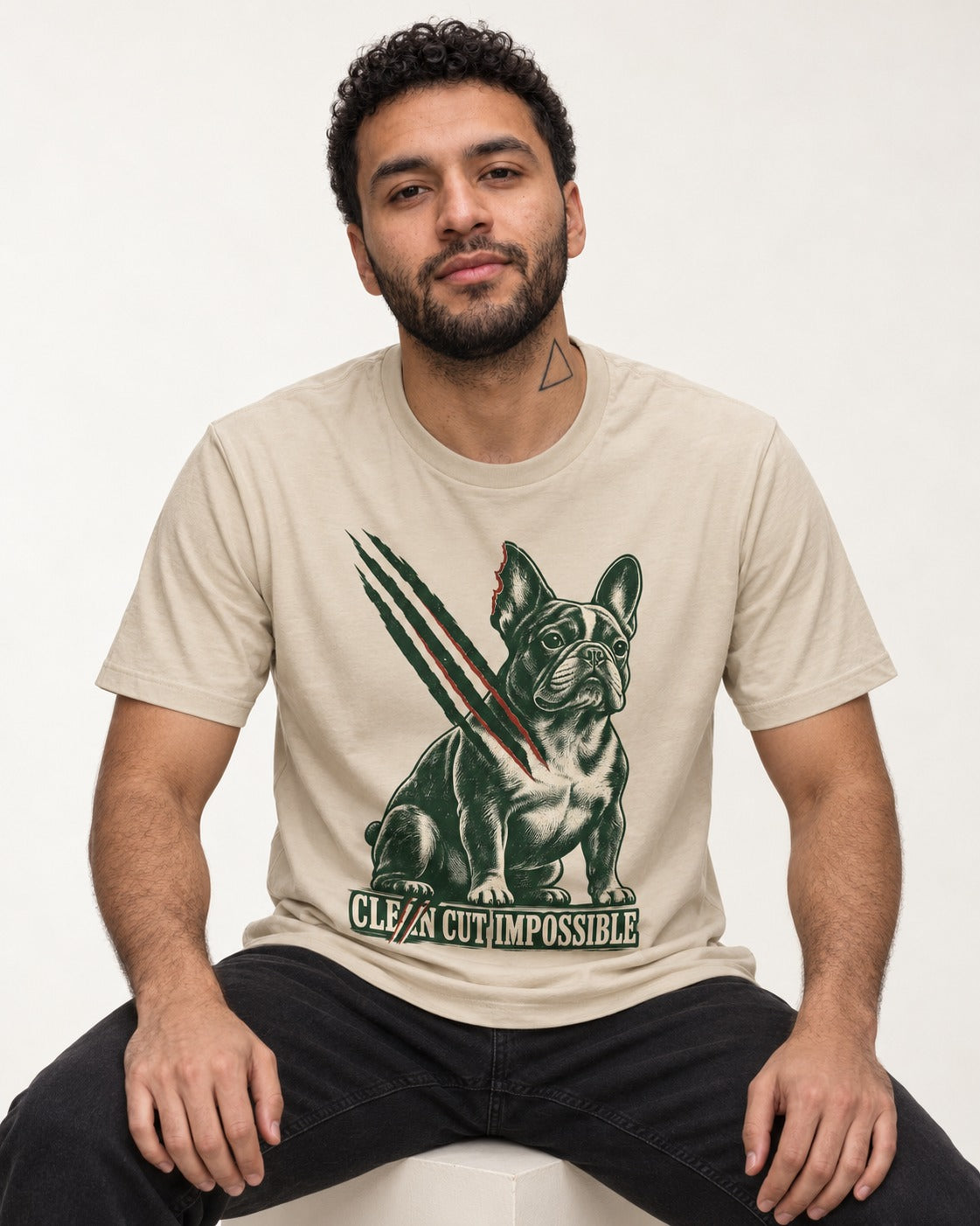 Frenchie Clean Cut Impossible T-Shirt in Sand, worn by a seated model