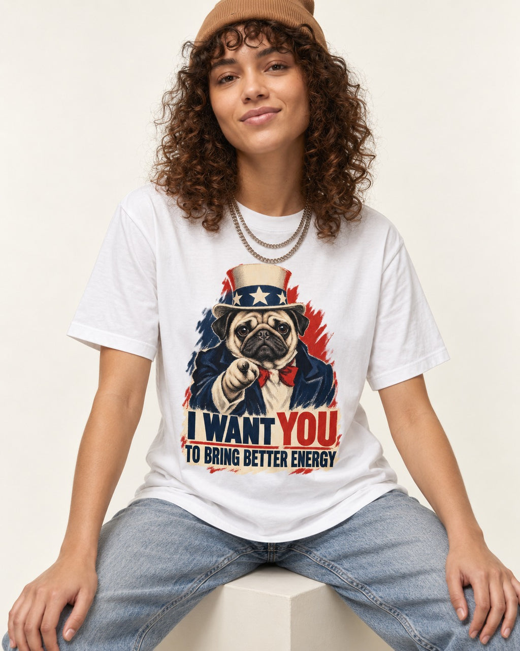 Pug I Want You to Bring Better Energy Uncle Sam Graphic T-Shirt in White, worn by a seated model