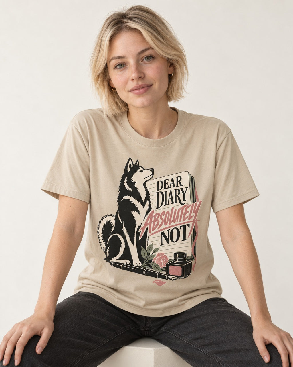 Husky Absolutely Not T-Shirt in Sand, worn by a seated model