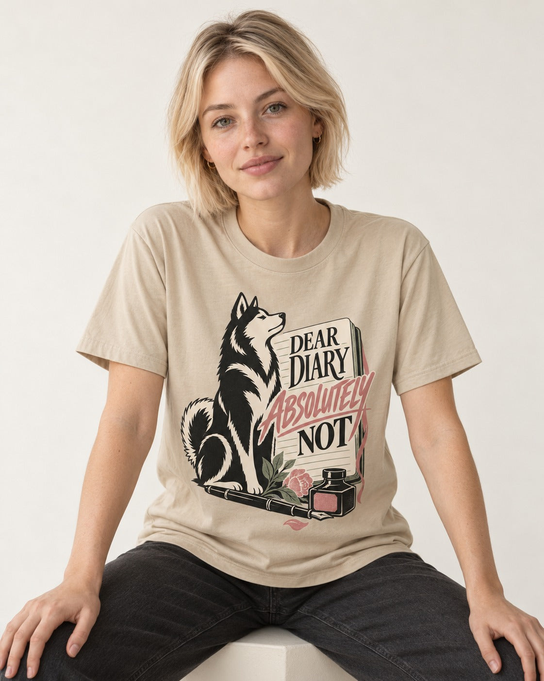 Husky Absolutely Not T-Shirt in Sand, worn by a seated model