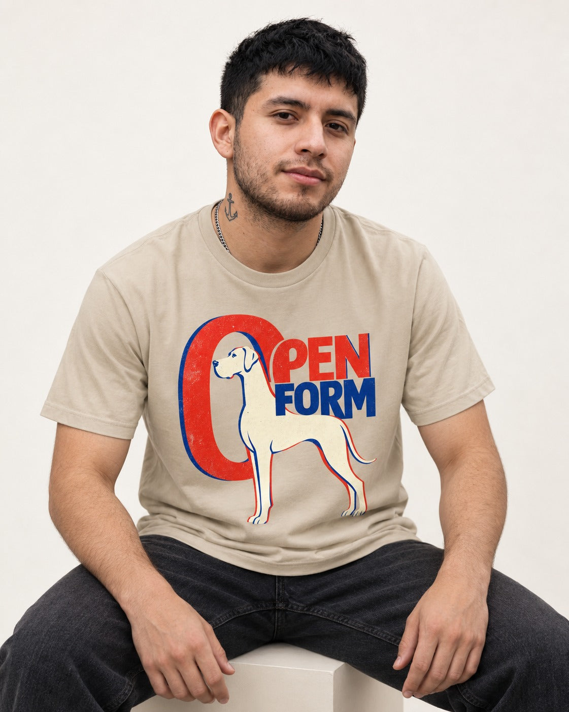 Open Form Great Dane T-Shirt in Sand, worn by a seated model
