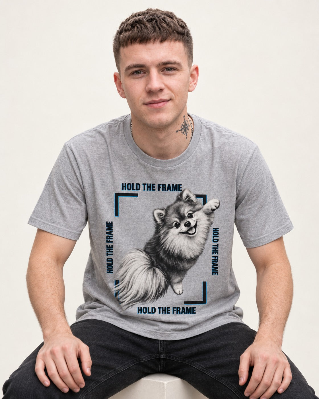 Hold the Frame Pomeranian T-Shirt in Sport Grey, worn by a seated model