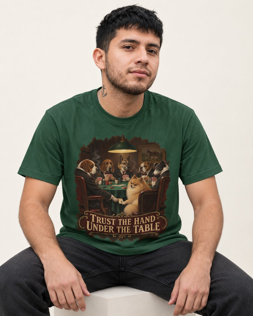 Pomeranian Trust the Hand Under the Table Poker Dogs Graphic T-Shirt in Forest Green, worn by a seated model