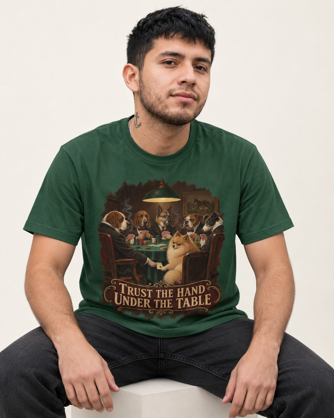Pomeranian Trust the Hand Under the Table Poker Dogs Graphic T-Shirt in Forest Green, worn by a seated model