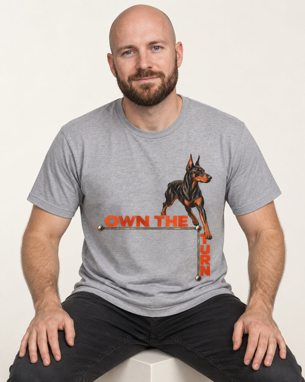 Own the Turn Doberman T-Shirt in Sport Grey, worn by a seated model